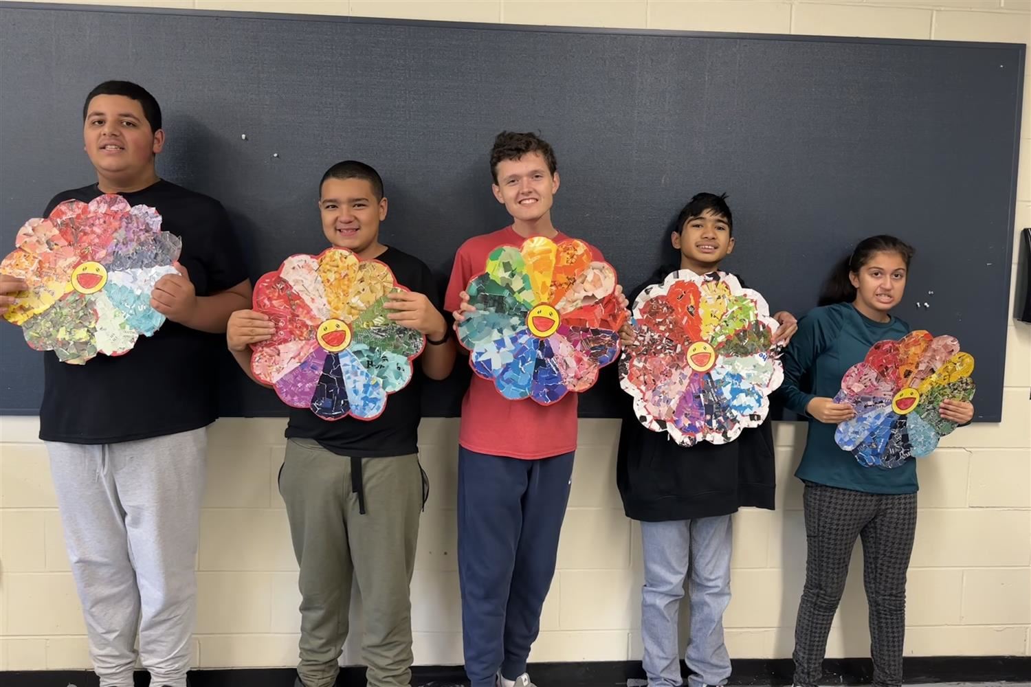  students holding art